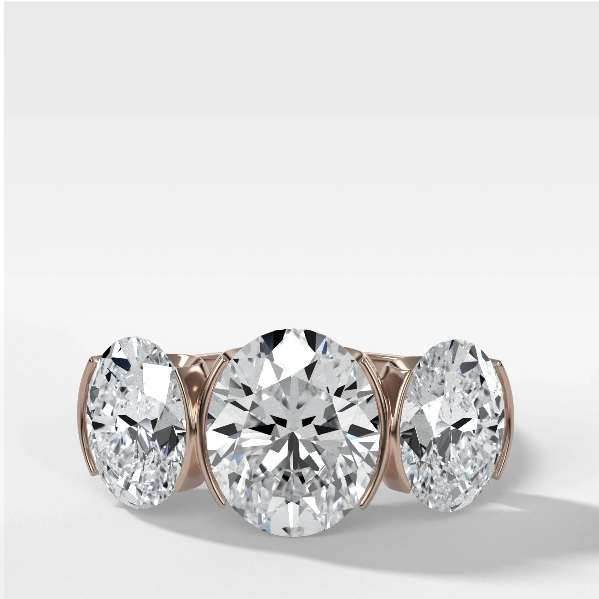 Half Bezel Triad Engagement Ring With Oval Cut Diamonds
