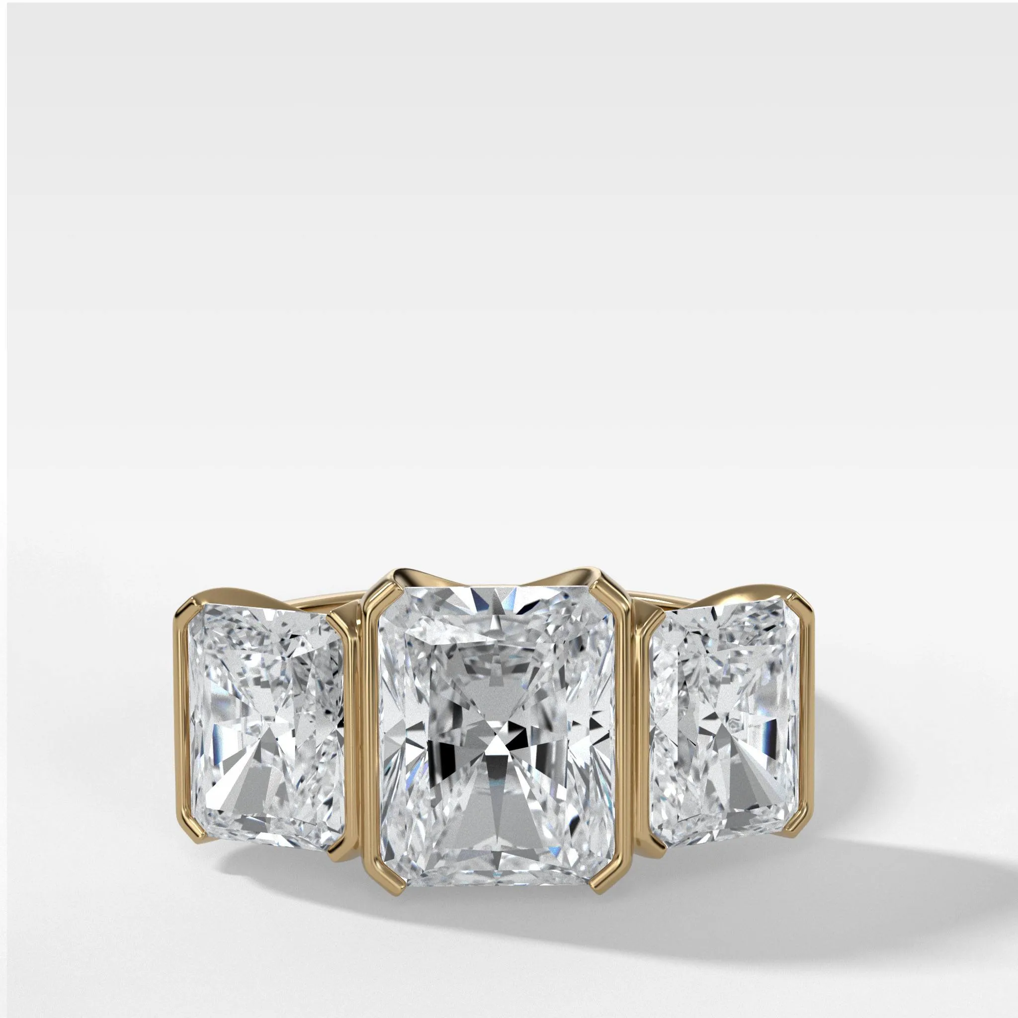 Half Bezel Triad Engagement Ring With Radiant Cut Diamonds