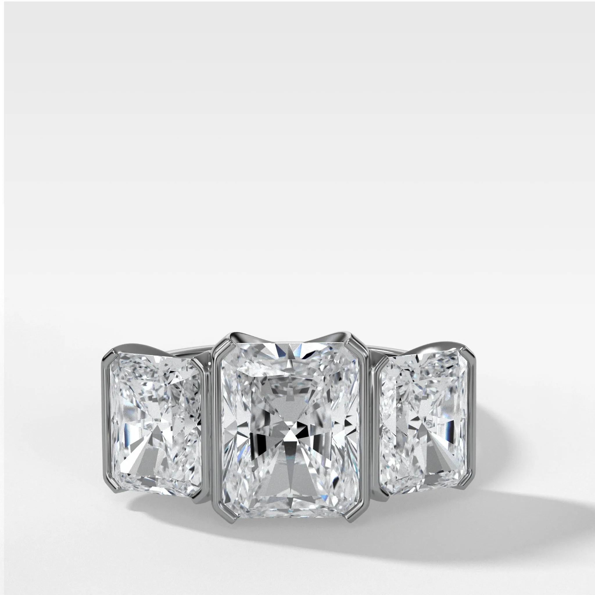 Half Bezel Triad Engagement Ring With Radiant Cut Diamonds