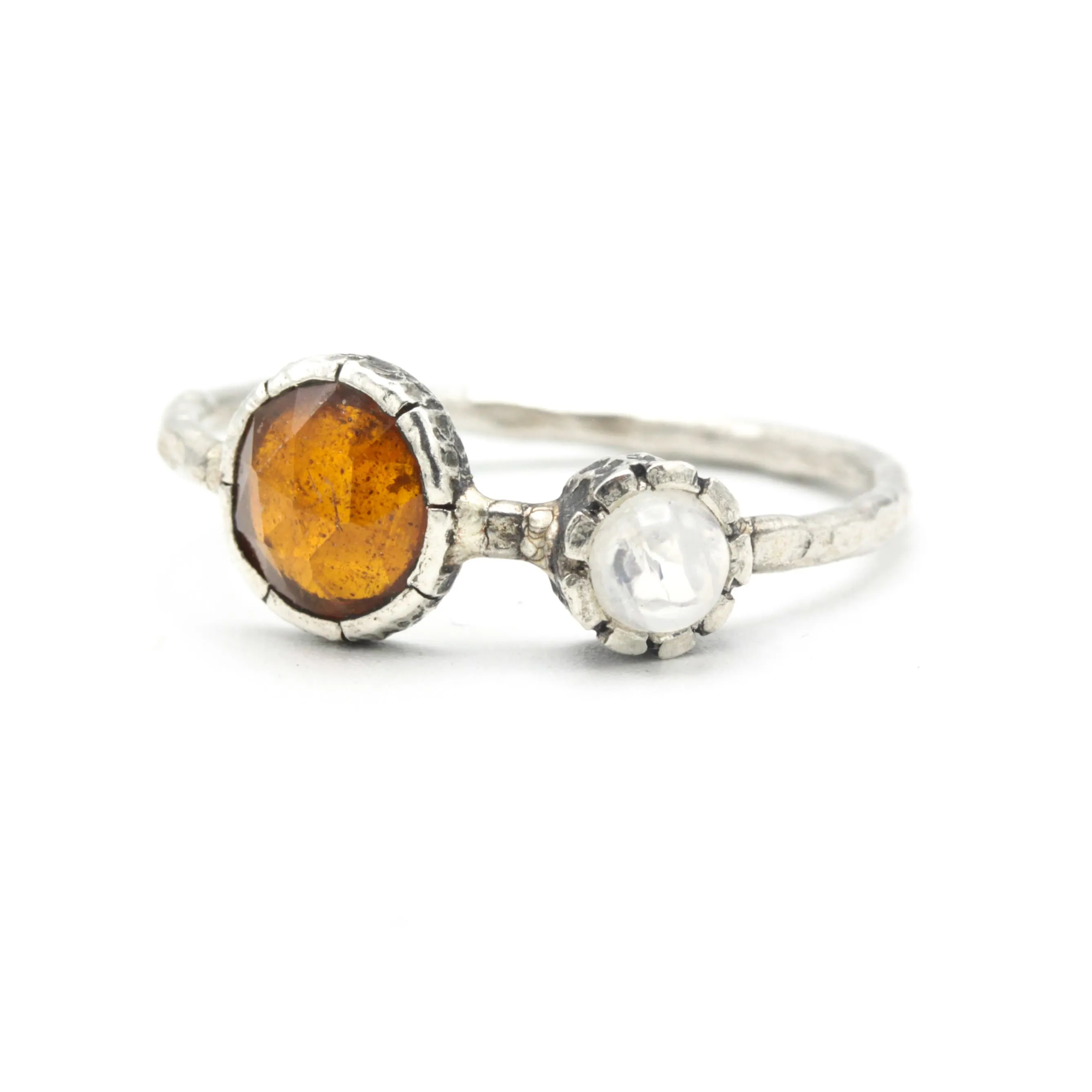 Round orange kyanite ring in silver bezel setting with Moonstone on the side on sterling silver hard texture band