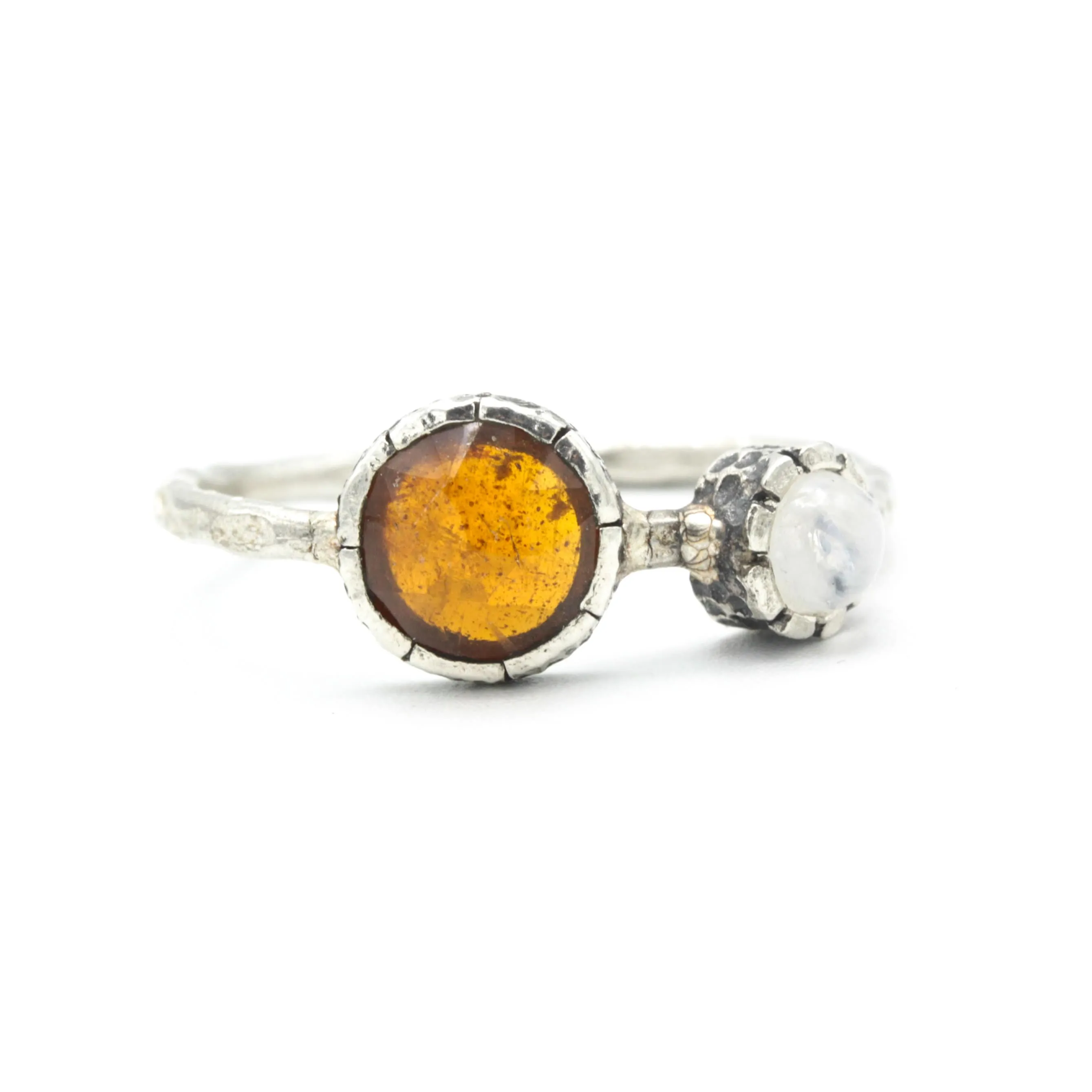 Round orange kyanite ring in silver bezel setting with Moonstone on the side on sterling silver hard texture band