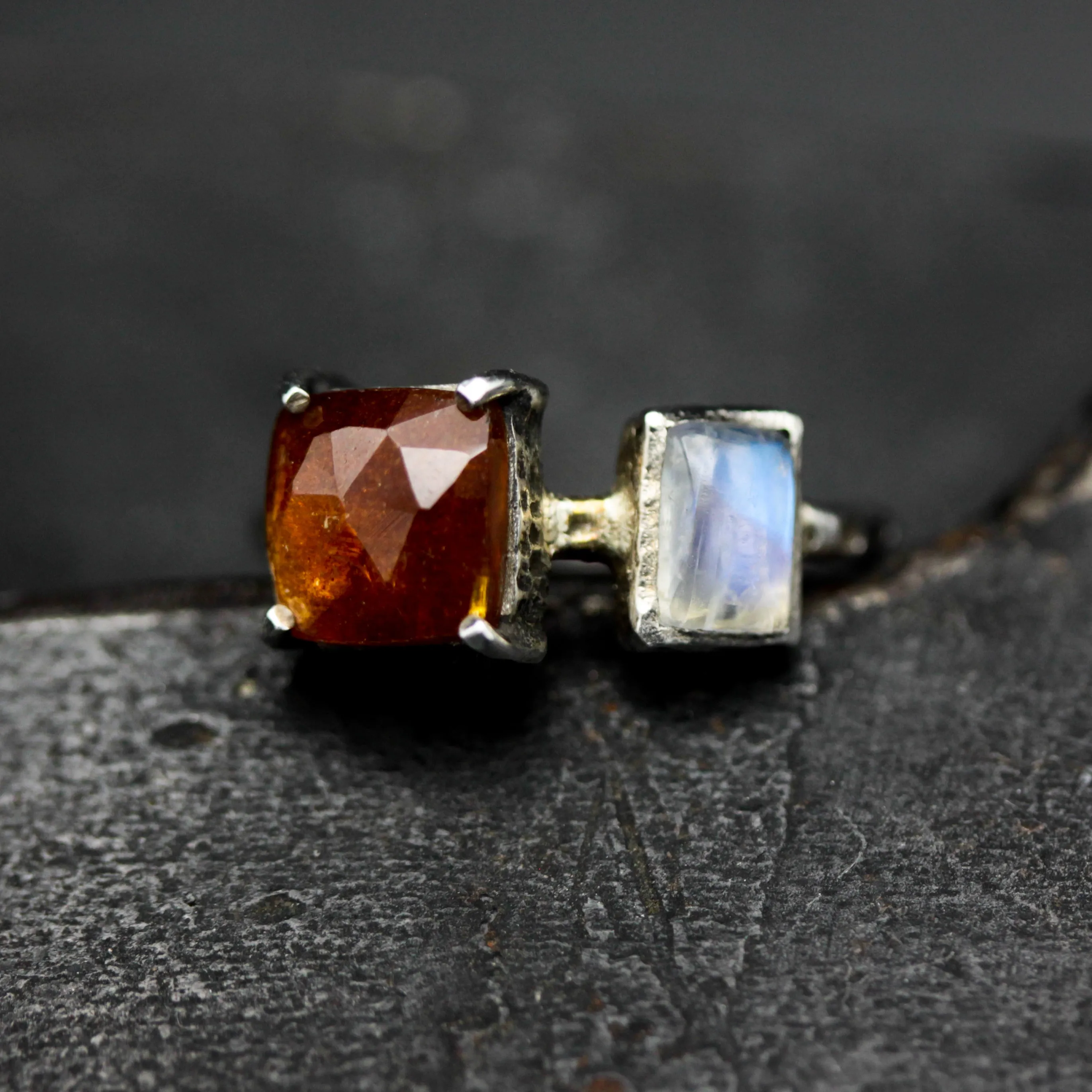 Square orange kyanite ring in silver bezel and prongs setting with Moonstone on the side on sterling silver texture band