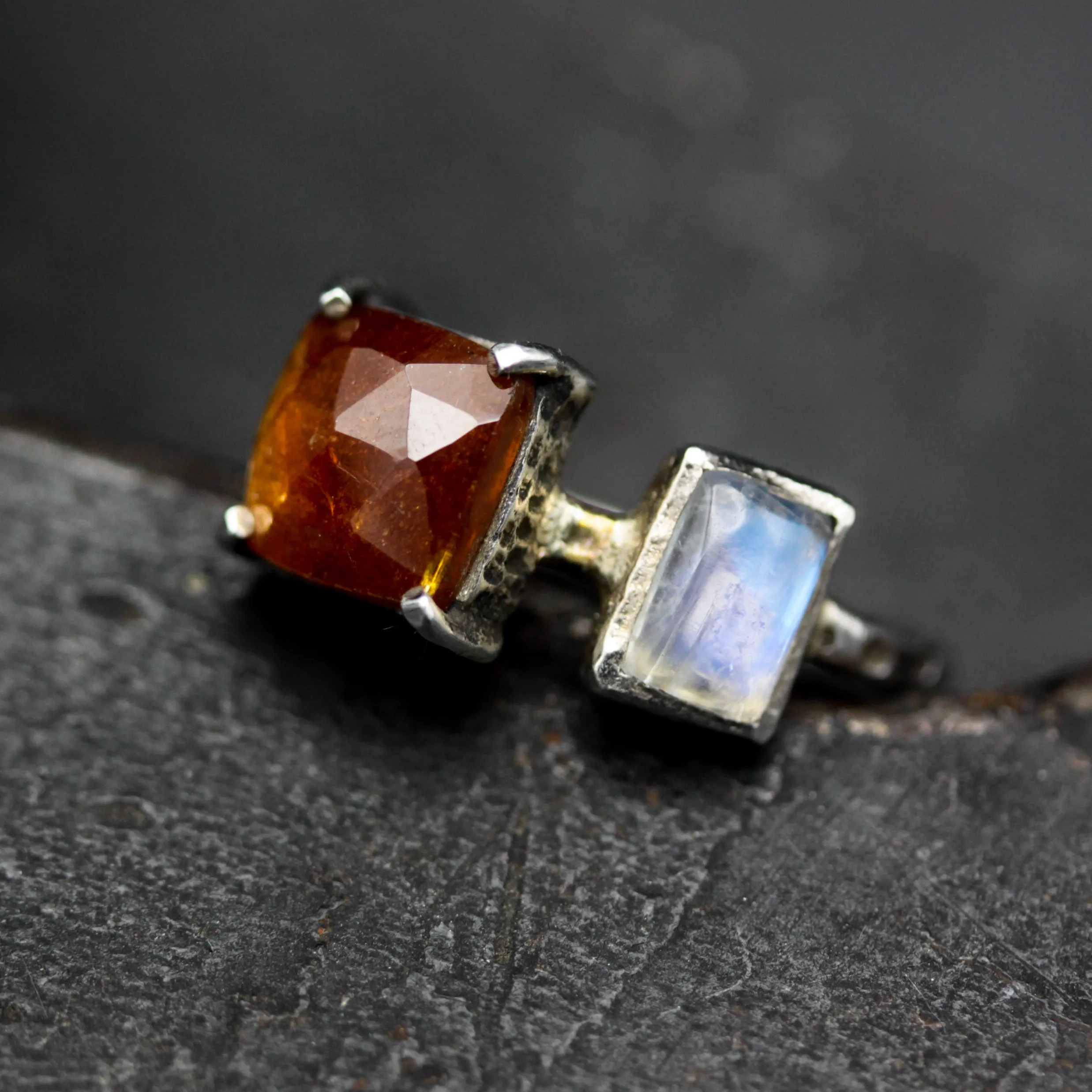 Square orange kyanite ring in silver bezel and prongs setting with Moonstone on the side on sterling silver texture band